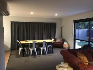 a living room with a table and chairs and a couch at Cromwell Retreat in Cromwell
