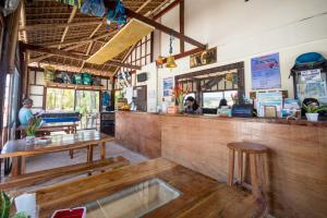 a bar in a restaurant with a table and a counter at Hangin Kite Resort in Boracay