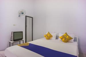 Giường trong phòng chung tại OYO 2277 Lulu Homes