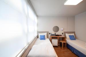 a hospital room with two beds and a desk at K-Grand Hostel Dongdaemun in Seoul