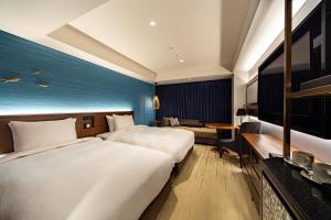 a hotel room with two beds and a couch at Hyatt Regency Tokyo Bay in Urayasu