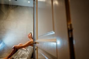 a woman in a wedding dress sitting in a shower at B&B Palazzo Cerami in Catania