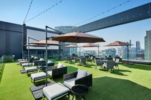 a bunch of chairs and umbrellas on a roof at Shilla Stay Samsung COEX Center in Seoul