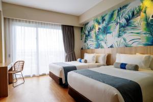 Rúm í herbergi á Solea Palm Resort Mactan