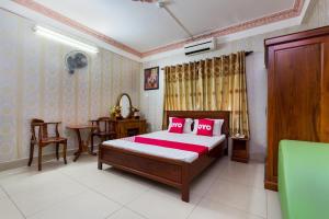 - une chambre avec un lit, une table et des chaises dans l'établissement OYO 476 Van Anh Hotel, à Hô-Chi-Minh-Ville