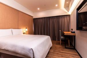 Postel nebo postele na pokoji v ubytování Fish Hotel Kaohsiung