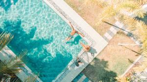 two people are swimming in a swimming pool at Green Hill Mirissa in Mirissa