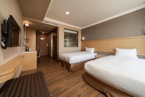 Krevet ili kreveti u jedinici u objektu Fish Hotel-Pingtung