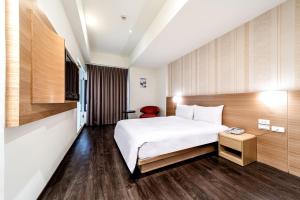 Ein Bett oder Betten in einem Zimmer der Unterkunft Fish Hotel - Yancheng