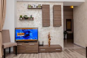 a living room with a flat screen tv on a wall at Summerland Sea View Apartment in Mamaia