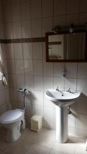 a bathroom with a sink and a toilet at Pension d'Avignon in Swakopmund +30 photos