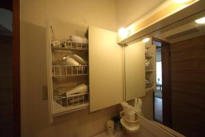 a bathroom with a medicine cabinet and a mirror at Exsaison house Kumoji in Naha +33 photos