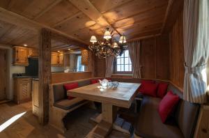 uma sala de jantar com uma mesa de madeira e cadeiras vermelhas em Chalet Berghof Sertig em Clavadel