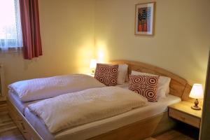 a bedroom with a bed with two pillows on it at Appartementhaus Habich in Bad Kleinkirchheim