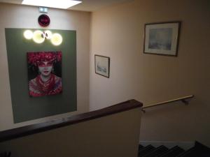 a hospital room with a picture of a woman on the wall at Quick Palace Le Mans in Saint-Saturnin