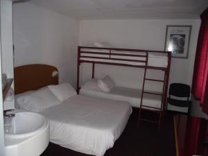 a bedroom with two bunk beds and a sink at Quick Palace Le Mans in Saint-Saturnin