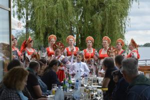 a group of people standing around a table at Pensiunea Paradise Delta House in Fîntîna Dulce