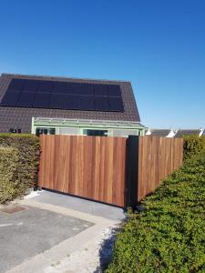 a wooden fence with solar panels on top of a house at Nieuwendamme 80 in Nieuwpoort