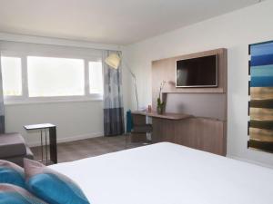 Postel nebo postele na pokoji v ubytování Novotel Avignon Nord