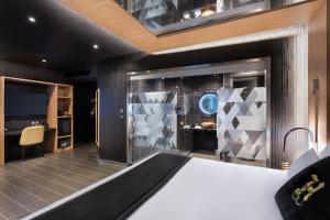a hotel room with a bed and a tv at H Hotel & SPA - Adults Only in St. Julianʼs