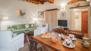 a living room with a table and a couch at Villa Casavecchia in San Casciano in Val di Pesa