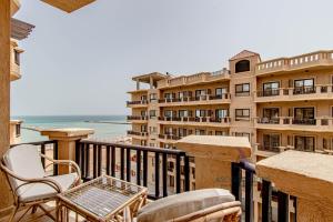 a balcony of a hotel with a table and chairs at SeaView Turtles in Hurghada