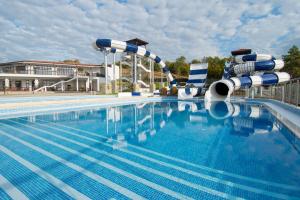 a large swimming pool with a water slide at Nevis Resort & Aqua Park - All Inclusive in Sunny Beach