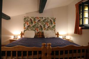 a bedroom with a large bed with a floral headboard at LES PIEDS DAND L'EAU in Banyuls-sur-Mer