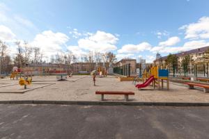 a park with a playground with slides and play equipment at Апартаменты на Геологоразведчиков in Tyumen
