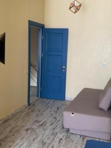 a blue door in a room with a bed at Апартаменты Золотой Бугаз in Karolino-Buhaz +31 photos