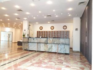 a lobby with a reception desk in a building at Hotel Pause in Hofheim am Taunus