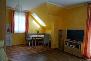 a living room with a table and a television at Ferienwohnung Koserow in Koserow