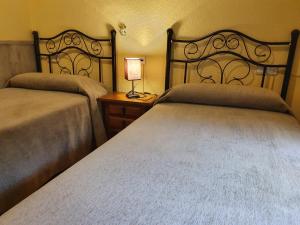 Postel nebo postele na pokoji v ubytování Arteaga Hostal & Baños Arabes Elvira