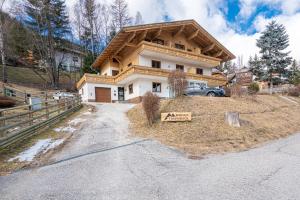 a large house on a hill with a driveway at Berghaus Traumblick in Bad Kleinkirchheim