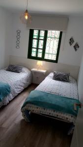 two beds in a room with two windows at Enjoy days of dreams in paradise, 2 BR with POOL in Maspalomas