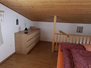 a bedroom with a bed and a dresser in a attic at Penzion 108 - Herlíkovice in Vrchlabí