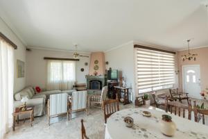 a living room with a couch and a table at villa nicol in Korinthos