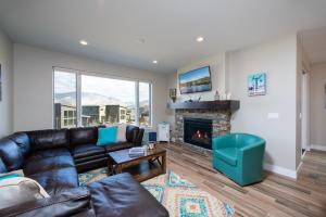 a living room with a couch and a fireplace at Gorgeous Decor with Private Hot Tub EW23 in Huntsville