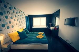 a blue bedroom with a teddy bear sitting on a bed at Chambre d'hôte Valère in Sion