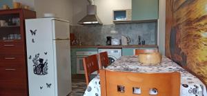 a kitchen with a table and a white refrigerator at Apartamento Mar deluxe Suances in Suances