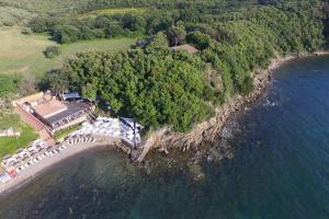 an aerial view of a house on an island in the water at Marina di Scarlino Resort in Puntone di Scarlino