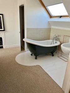 un bagno con vasca e lavandino di Beautiful 4 Bed Beach House a Pevensey