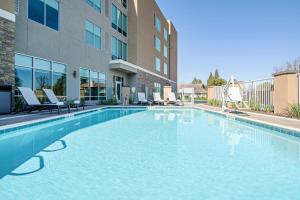 a swimming pool in front of a building at Hyatt Place Bakersfield in Bakersfield