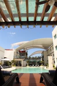 a swimming pool in a building with a bridge at Hotel Tulija Palenque in Palenque