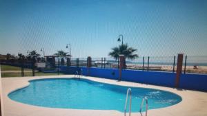a swimming pool with the beach in the background at Lances playa in Tarifa