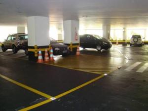 a parking lot with cars parked in a parking garage at Gallant Hotel in Rio de Janeiro
