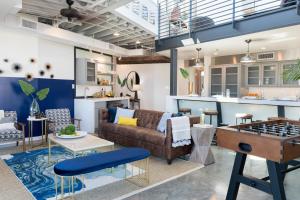 a living room with a couch and a chessboard at Luxury Arts District Apartments in New Orleans