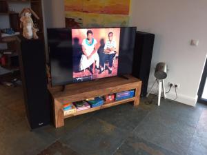 a flat screen tv sitting on top of a wooden entertainment center at das Haus in Jois in Jois