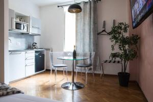 a kitchen with a table and chairs in a room at Pink Intimate Jacuzzi Suite Trastevere - Top Collection in Rome