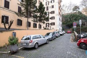 a row of cars parked on the side of a street at Pink Intimate Jacuzzi Suite Trastevere - Top Collection in Rome